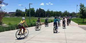 Group riding away from the Rec Center on bikes