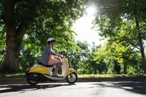 A Colorado State Universit staff member rides her motor scooter on campus, September 9, 2015.