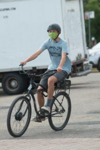  photo of bicyclist wearing mask and helmet
