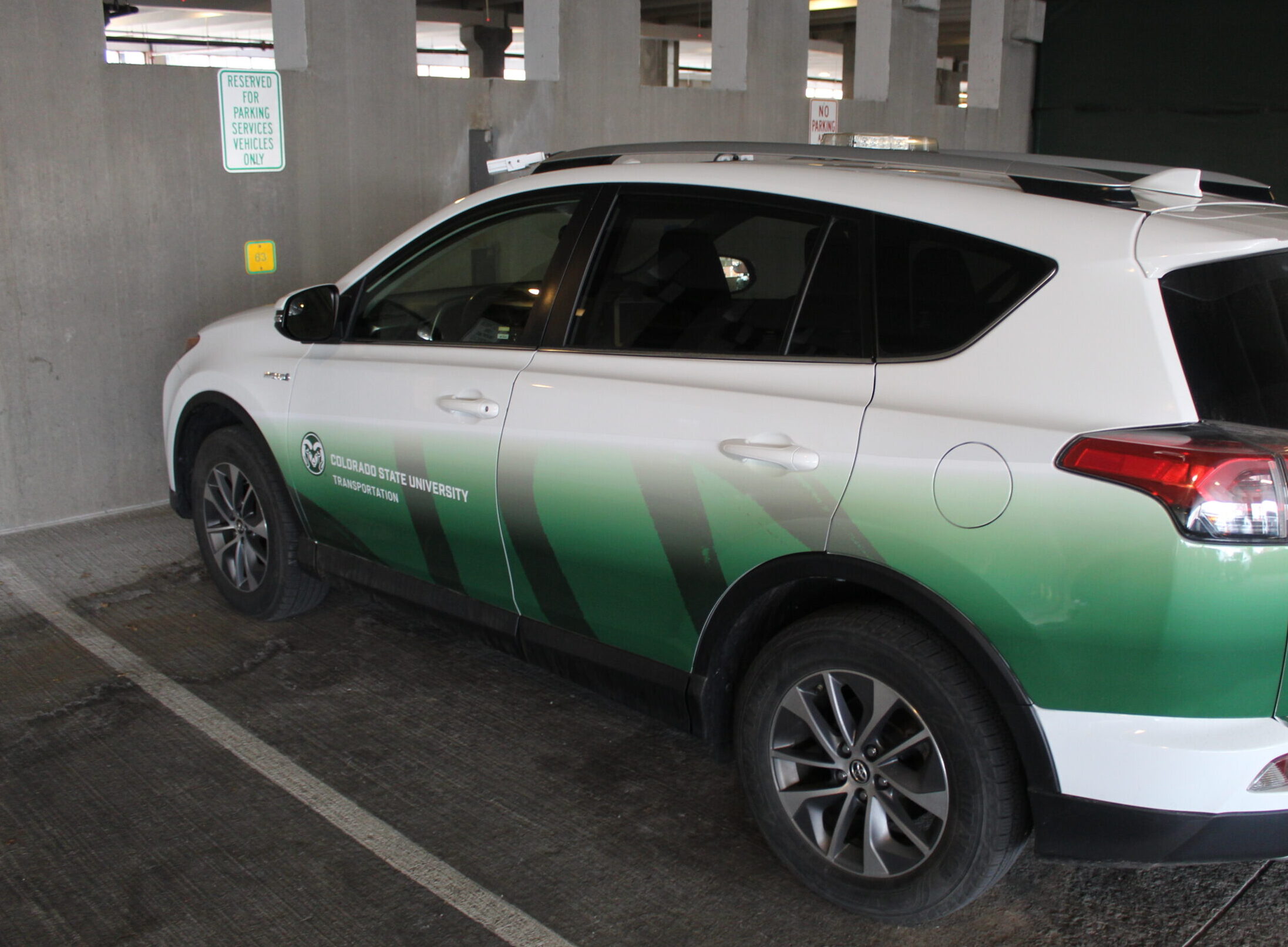 CSU Transportation vehicle parked in a reserved spot.